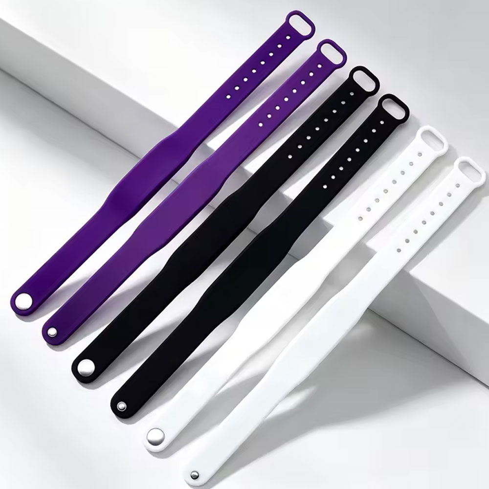 Six silicone NFC wristbands in purple, black and white.