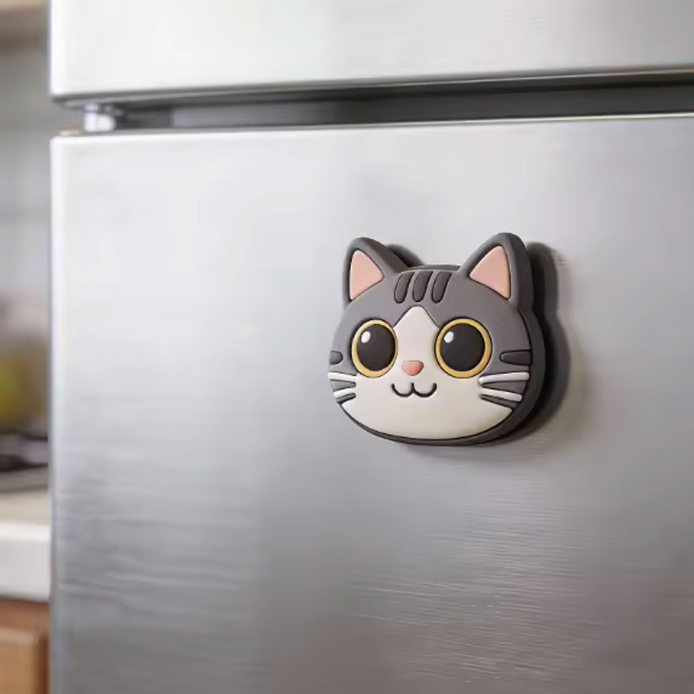 A cat-shaped NFC magnet on a fridge door.